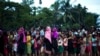 FILE - Rohingya Muslims, who crossed over recently from Myanmar into Bangladesh, wait to receive food being distributed near Balukhali refugee camp in Cox's Bazar, Bangladesh, Sept. 19, 2017.