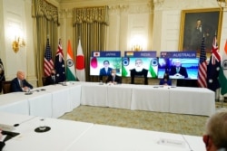 FILE - President Joe Biden speaks during a virtual meeting with Indian Prime Minister Narendra Modi, Australian Prime Minister Scott Morrison and Japanese Prime Minister Yoshihide Suga, from the State Dining Room of the White House, March 12, 2021.