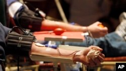 FILE - Donors give blood at record attempt for blood donations, Rutland, Vt., Dec. 2011.