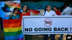 A group of Indian activists hold a banner against section 377 of the Indian Penal Code that criminalizes homosexuality during a protest in Mumbai, India, Dec. 11, 2013.