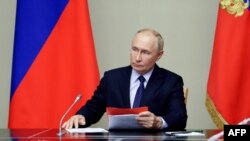 In this pool photograph distributed by Russian state owned Sputnik agency President Vladimir Putin chairs a meeting with Security Council permanent members on the situation in the Kursk region, in his residence outside Moscow on August 9, 2024.