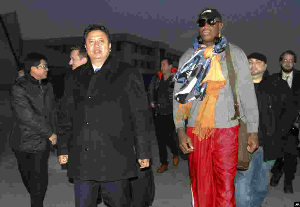Dennis Rodman walks with Vice Minister of North Korea's Sports Ministry, Son Kwang Ho, as Rodman arrives at the international airport in Pyongyang, Dec. 19, 2013.