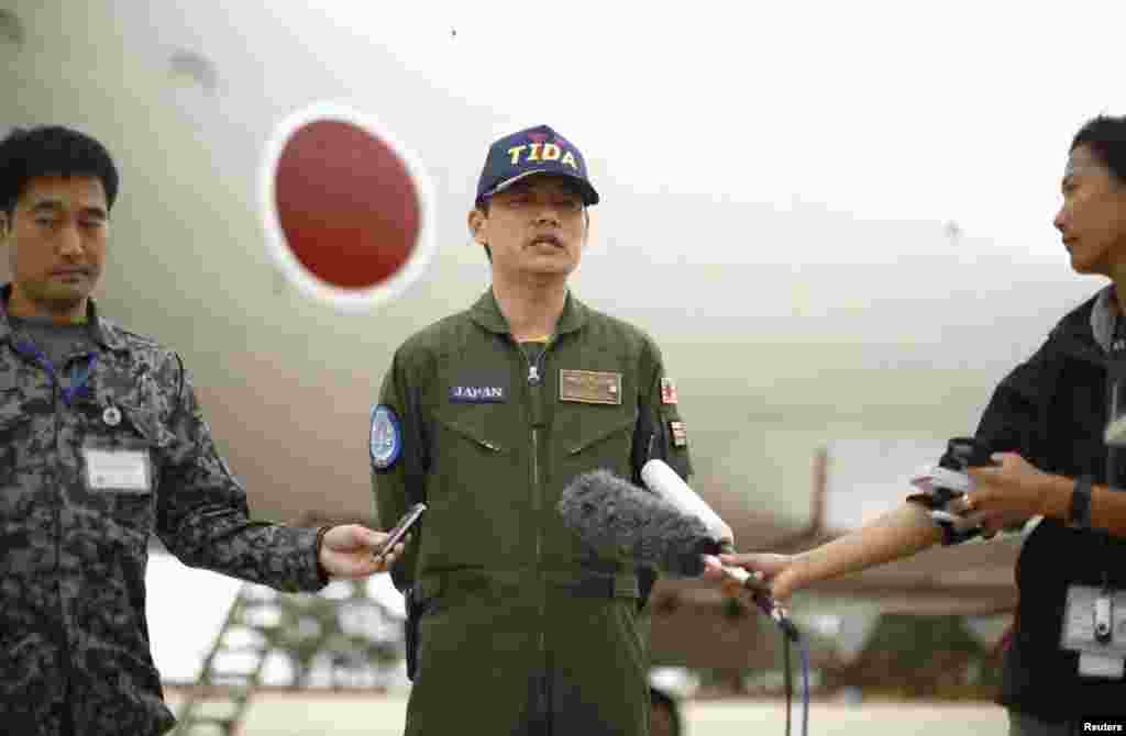 Japan's Maritime Self-Defense Force Commander Hidetsugu Iwamasa speaks to the press in front of one of their P-3C Orion aircraft currently at RAAF Base Pearce near Perth, Australia, April 4, 2014.