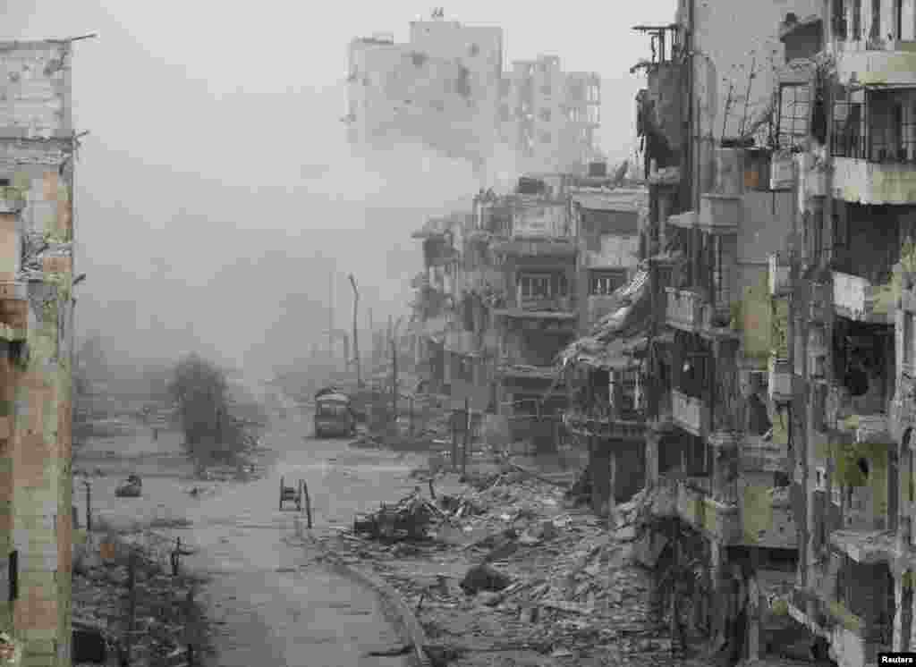Smoke rises from buildings after what activists said was shelling from forces loyal to Syria's President Bashar al-Assad in the besieged area of Homs, Jan. 15, 2014.