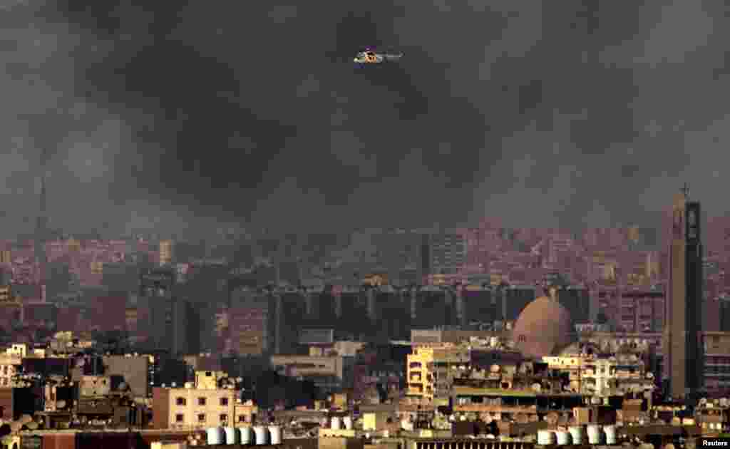 A military helicopter among clouds of smoke in Cairo, July 26, 2013.